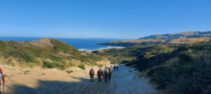 Walking down sand to Sandfly Beach Caption and photo Helen