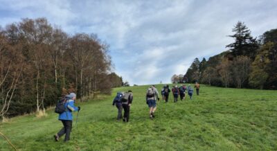 20 may town belt hikers up the hill monticello through long grass. photo & caption helen